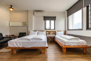 En eller flere senger på et rom på Mini Voyage Hostel