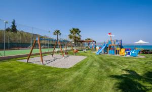 a park with a playground with a swing set at Kiani Beach Resort Family All Inclusive in Kalyves