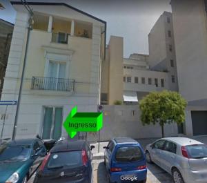 a group of cars parked in front of a building at Central Apartment - Residenza Battistessa in Caserta