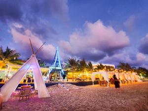 a group of tents on a beach at night at Saint Tropez Beach Hotel in Chao Lao Beach