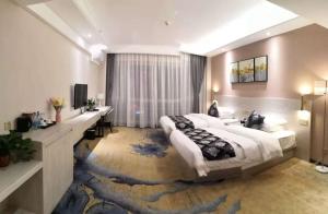 a large bedroom with a large bed and a desk at Demei Boutique Hotel in Kunming