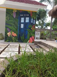 a building with a blue door with flowers on it at Nipah Villas in Senggigi 