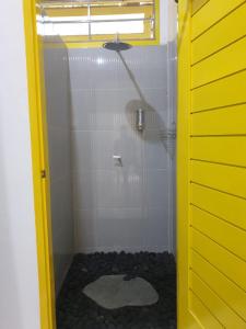 a bathroom with a shower with a toilet in it at Nipah Villas in Senggigi 