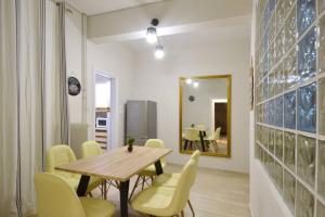 a dining room with a wooden table and yellow chairs at Plaka, Apartment in the old historical neighborhood of Athens in Athens