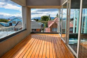 a balcony with a view of a house at Natalino Hotel Patagonia in Puerto Natales