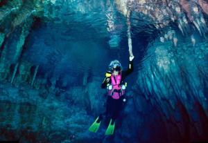 a person on skis hanging from a rope in a cave at Villa la Ficuzza in Cittadella del Capo