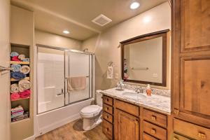 a bathroom with a sink and a shower and a toilet at 1 Mi to Rainbow Lake Newly Built and Woodsy Retreat in Lake of the Woods +20 photos