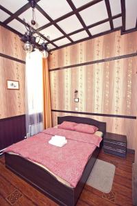 a bedroom with a large bed with red pillows at Apartments Castle on Uvildy Lake in Uvildy