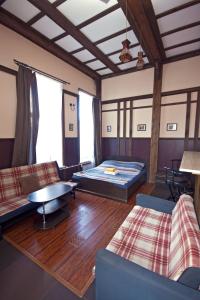 a living room with two beds and a table at Apartments Castle on Uvildy Lake in Uvildy