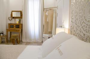 a bedroom with a bed and a desk and a shower at Infinito Hotel Boutique - Adults Only in Ciutadella