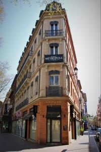 a large brick building with a sign on it at Residence Metropole Toulouse in Toulouse