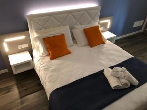 a bedroom with a large bed with two towels on it at B&B Alma Garda Lake in Peschiera del Garda +43 photos