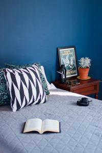 a bed with an open book on top of it at Casa Arrayan in Guadalajara