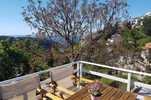 a wooden bench sitting on top of a balcony at Chariklia Traditional House in Alonnisos Old Town