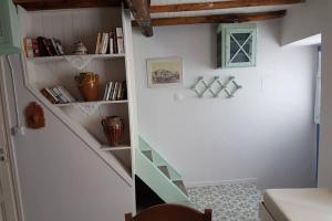 a room with a stairway with bookshelves at Chariklia Traditional House in Alonnisos Old Town