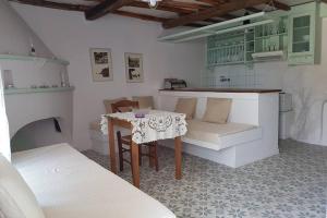 a living room with a table and a couch at Chariklia Traditional House in Alonnisos Old Town