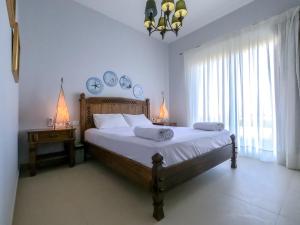 a bedroom with a large bed and a window at Exotic Retreat 2 BR Apartment in Water Side Lagoon Pool in Hurghada