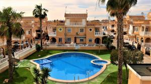 an aerial view of a mansion with a swimming pool and palm trees at Sol Beach 24 in Playas de Orihuela