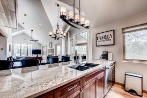 a kitchen with a large counter top and a living room at Frisco River Townhomes #D in Frisco