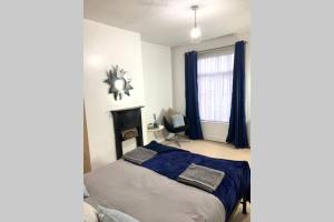 a bedroom with a bed and a fireplace in it at City STAY in Leeds