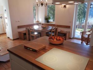 a kitchen and dining room with a table and chairs at Zbilje Lake House in Medvode