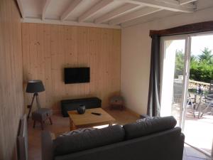 a living room with a couch and a table at Figuier résidence Domaine Cap de Coste in Saint-Frajou