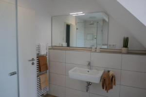a bathroom with a sink and a mirror at Hotel van Lendt garni in Dülmen +33 photos