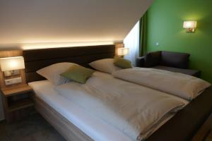 a bedroom with two large beds with green walls at Hotel van Lendt garni in Dülmen