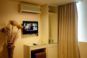 TV a/nebo společenská místnost v ubytování Mangga Boutique Hotel