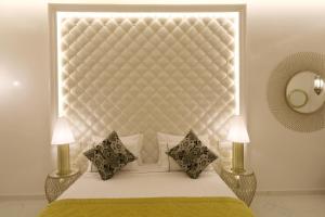 a bedroom with a bed with a large headboard at Riad Andallaspa in Marrakech