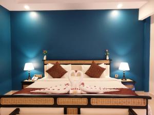 Ein Bett oder Betten in einem Zimmer der Unterkunft Aristocrat Residence & Hotel