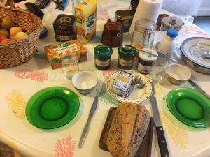 a table with green plates and sandwiches on it at chez françoise in La Roche-des-Arnauds