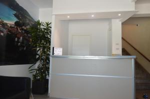 a white cabinet in a room with a plant at Hostal Solymar in Louro