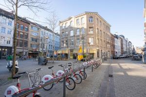 a row of bikes parked on a city street at SHWAY - The Pink Pigeon in Antwerp