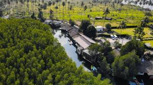 an aerial view of a river with a building and trees at Escape Life Koh Kood in Ko Kood