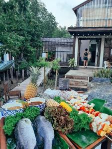 a table filled with lots of vegetables and fruits at Escape Life Koh Kood in Ko Kood