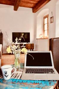 a laptop sitting on a table in a living room at Apartments Altstadthaus Görlitz in Görlitz