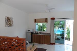 a kitchen with a sink and a refrigerator at Baan Sabaaidee - Adult Friendly in Hua Hin