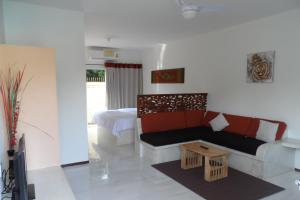 a living room with a couch and a bed at Baan Sabaaidee - Adult Friendly in Hua Hin