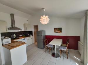 a kitchen with a table and chairs in a kitchen at Gîte Les Rapières in Gordes