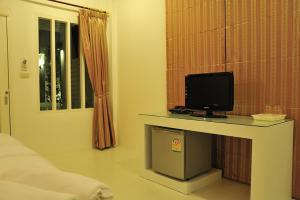 a room with a desk with a television on it at Clear House Phuket in Kamala Beach
