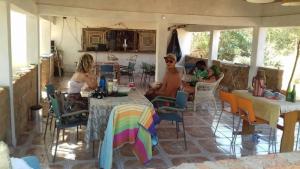 a group of people sitting at tables in a kitchen at Camping Sitaba Lodge in Georgetown