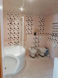 a bathroom with a tub and a toilet and a sink at Irene apartments in Druskininkai +12 photos