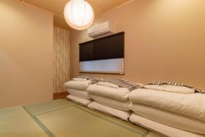 Ένα ή περισσότερα κρεβάτια σε δωμάτιο στο Bijou Suites Miyabi