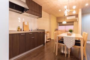 a kitchen and dining room with a table and chairs at Bijou Suites Miyabi in Osaka