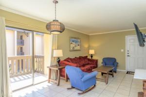 a living room with a couch and a table and chairs at Tiki 231 in South Padre Island