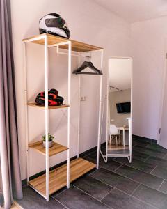 a room with white shelves and a mirror at Racers Home Nürburg in Nürburg