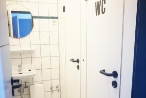 a bathroom with a toilet and a sink and a mirror at Work & Stay in Emmerich in Emmerich