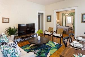 a living room with a couch and a table at 1858 Edgeland Avenue, Unit One in Louisville