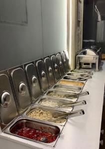 une rangée de plateaux de nourriture sur un comptoir dans l'établissement Vision Apartment, à Buraydah
